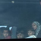 Una mujer y sus hijos, a bordo del autobús que les ha sacado del campo de Idomeni, esta mañana.