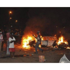 Transeúntes nigerianos contemplan los efectos de la explosión en Abuya.