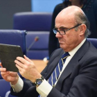 Luis de Guindos mira su tableta durante una reunión del Eurogrupo celebrada en Luxemburgo.