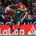 El defensa del Atlético Stefan Savic lucha por el balón contra Loren Morón, del Real Betis. KIKO HUESCA