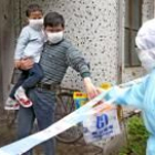 Personal sanitario lleva comida a uno de los complejos residenciales en cuarentena en Sanghai