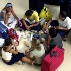 Un grupo de jóvenes comen bocadillos en una estación.