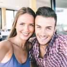 Pareja joven haciéndose un selfie.