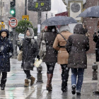 Varias personas pasean por una céntrica calle de Granada durante un temporal de lluvia y frío del pasado invierno.