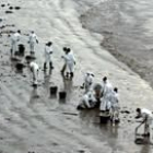 Militares y voluntarios se afanan en limpiar la playa de Langosteira