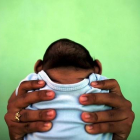 Jackeline sostiene a su hijo de 4 meses de edad y nacido con (Zika) microcefália frente a su casa en Olinda, cerca de Recife, Brasil, en una imagen de archivo.