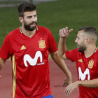 Piqué conversa con Jordi Alba durante el entrenamiento más complicado del central culé. CHEMA MOYA