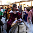 Niños y niñas disfrutan de un paseo en burro por el mercado medieval.