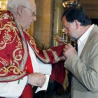 Rajoy besa la Cruz de Caravaca en su visita a Murcia.