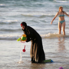 Una musulmana se baña con el hiyab en la playa en Tel Aviv.