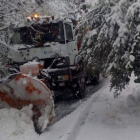 Una máquina quitanieves trabaja para despejar la vía de nieve y ramas en el municipio de Posada de Valdeón. DL