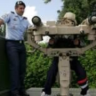 Un niño mira por el visor de una de las armas del Ejército