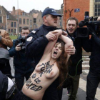La policía francesa se lleva a rastras a una de las activistas de Femen que ha asaltado el vehículo de Strauss-Khan a su llegada al juzgado, este martes.