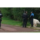 La mujer, sentada en un banco de la zona peatonal del río,  por una manta y acompañada por los policías que acudieron a su rescate