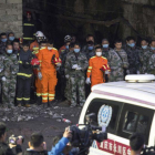 Los equipos de rescate hacen un minuto de silencio por los mineros muertos tras encontrar sus cuerpos sin vida, el martes, en la provincia de Chongqing (China)