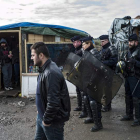 Agentes de la CRS patrullan el campamento temporal La Jungla, en las afueras de Calais. YOAN VALAT