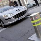 Un coche espera a que baje uno de los nuevos y «ecológicos» bolardos