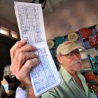 Un cubano muestra su cartilla de racionamiento.
