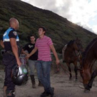 Un policía de la Patrulla Verde, ayer tarde junto a dos vecinos de Toral de Merayo con sus caballos.
