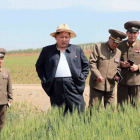 Kim Jong-un en una inusual imagen con su chaqueta abierta durante la visita a una granja.
