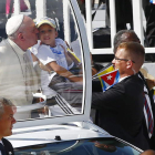 El papa besa a un niño en la localidad de Holguín.