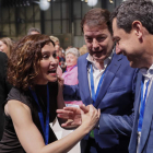 Ayuso con Mañueco y Moreno ayer, en la convención del PP de Madrid. MARISCAL