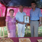 El artesano invitado Manuel Parrado recibe un obsequio de manos del alcalde.