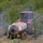 Imagen de un tractor fumigando una plantación de manzanas en el Bierzo. L. DE LA MATA