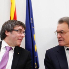 El 'president' Carles Puigdemont y el 'expresident' Artur Mas, en la sede del PDECat en Barcelona.