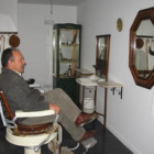 El alcalde, sentado en la sala de la barbería
