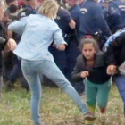 Imagen de un video en la que se ve a la reportera Petra László como hace la zancadilla a una niña refugiada que huye de la policía en el campo de Roszke.