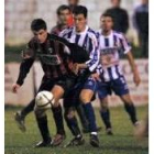 Alberto Rivadulla trata de sujetar a Pastrain durante el partido de ayer en Arlonagusia