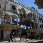 Un hombre camina ayer entre edificios destruidos de una ciudad siria