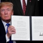 Donald Trump muestra su firma en el mermorándum sobre China. /