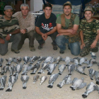 Un grupo de cazadores muestra las piezas cobradas al final de su jornada en el campo.