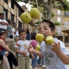 Un niño intenta comerse una manzana