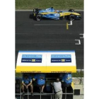 Alonso pasa con su coche en un entrenamiento frente a sus técnicos