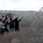 Un grupo de palestinos desafía a soldados israelíes en la frontera con Gaza.