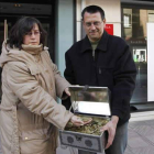 Nohelia y Florencio muestran las monedas antes de entregarlas en la oficina.