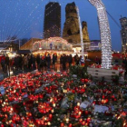 Altar de flores y velas en el mercadillo navideño de Berlín, que ayer reabrió.