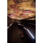 Una mujer hace fotos a la neocueva de Altamira. PEDRO PUENTE HOYOS