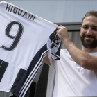 El delantero Gonzalo Higuaín muestra a sus aficionados su nueva camiseta de la Juventus.