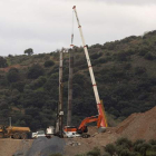 Una grúa mantiene suspendido el tubo en el lugar de los trabajos porque un nuevo saliente dificulta el rescate de Julen. DANIEL PÉREZ