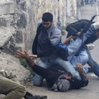 Agentes de paisano israelís detienen a varios palestinos durante los enfrentamientos en Jerusalén.