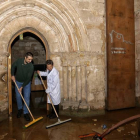Dos hombres achican agua en el monasterio de Santa María la Real de Aguilar de Campóo. BRÁGIMO