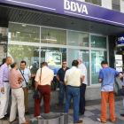 Un grupo de personas frente a una oficina de BBVA. L. DE LA MATA