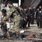 La policía afgana recoge algunas pertenencias de las víctimas de los atentados en Kabul.