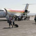 Pasajeros en la pista del aeropuerto tras el aterrizaje.