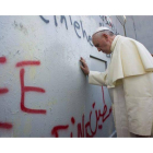 El Papa reza ante el muro que divide Israel y Palestina, en una parada imprevista en su recorrido por Belén, este domingo.