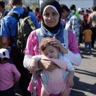 Una refugiada siria con su hija tras llegar a Grecia.